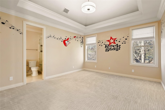 unfurnished bedroom featuring carpet floors, a raised ceiling, visible vents, and baseboards