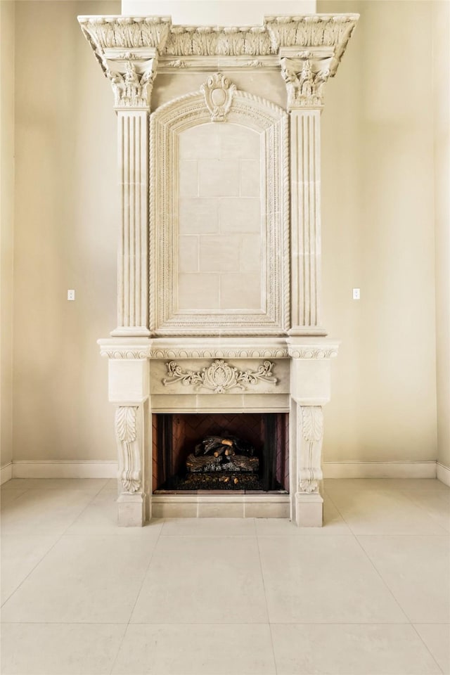 interior details featuring a large fireplace and baseboards