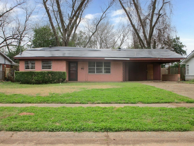 view of front of home with a carport, brick siding, concrete driveway, and a front yard