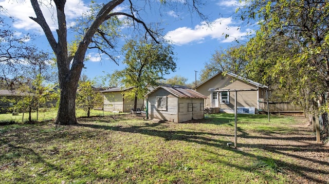 view of home's exterior featuring a yard, an outdoor structure, and a fenced backyard