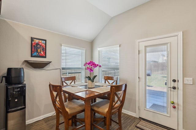 dining space with baseboards, vaulted ceiling, and dark wood-type flooring