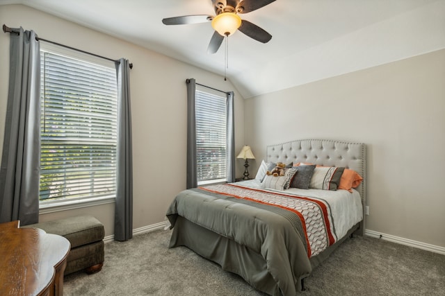 carpeted bedroom with lofted ceiling, multiple windows, a ceiling fan, and baseboards