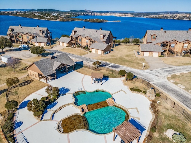 drone / aerial view with a residential view and a water view