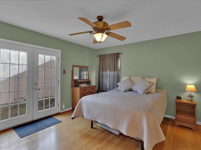 bedroom with access to exterior, french doors, a ceiling fan, light wood-type flooring, and baseboards