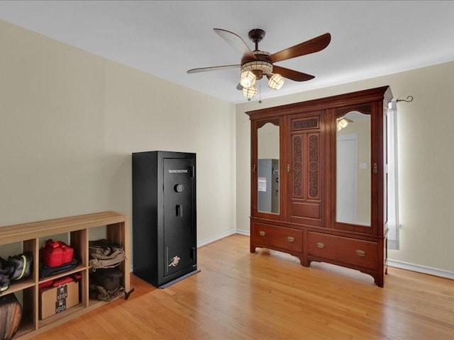 interior space with light wood-type flooring, baseboards, and a ceiling fan