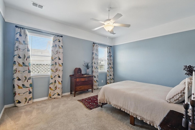 carpeted bedroom with ceiling fan, visible vents, and baseboards