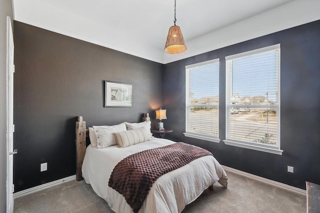 carpeted bedroom featuring baseboards