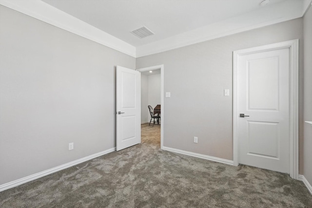 unfurnished bedroom featuring carpet floors, visible vents, and baseboards