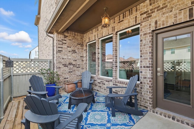 view of patio / terrace featuring a fire pit and fence