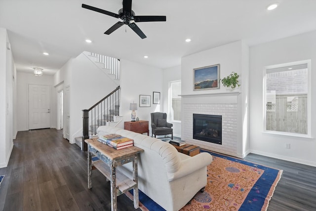 living area featuring stairs, dark wood-type flooring, and recessed lighting