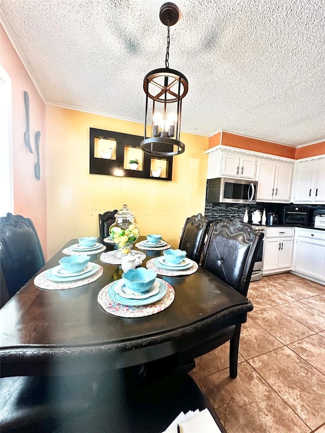 dining area with a textured ceiling and light tile patterned floors