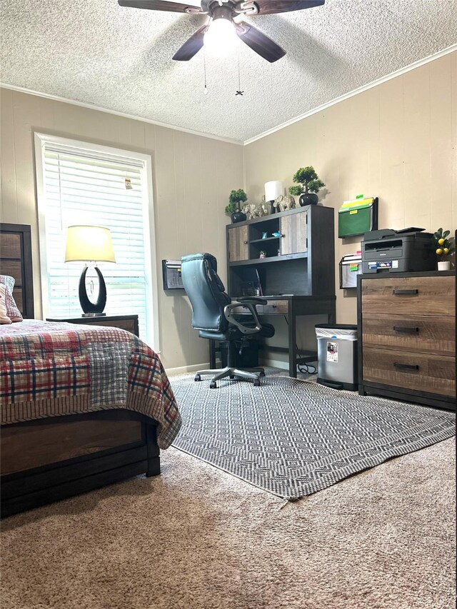 carpeted bedroom featuring a textured ceiling, a ceiling fan, and crown molding