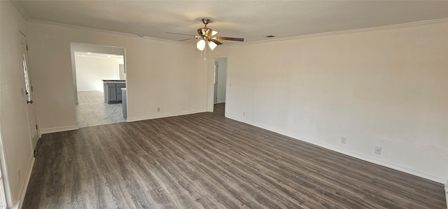 unfurnished room featuring dark wood-style floors, ornamental molding, baseboards, and ceiling fan