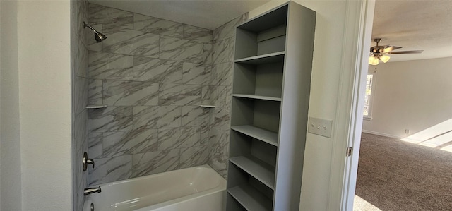 bathroom featuring ceiling fan and washtub / shower combination