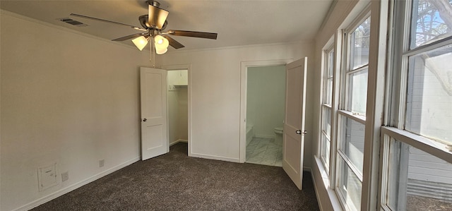 unfurnished bedroom with dark carpet, crown molding, baseboards, and ceiling fan