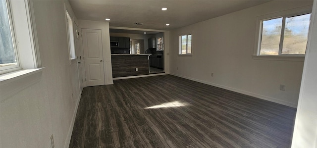 spare room with dark wood-style floors, recessed lighting, and baseboards