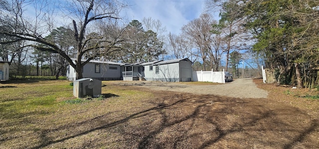 view of yard featuring driveway and fence