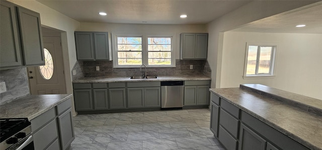 kitchen with stainless steel appliances, marble finish floor, a sink, and gray cabinetry