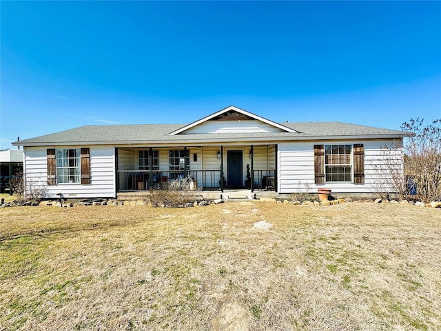 ranch-style home with covered porch and a front lawn