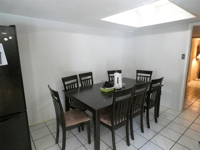 dining area featuring light tile patterned flooring