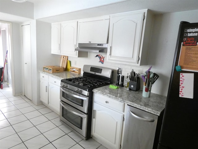 kitchen featuring freestanding refrigerator, white cabinets, double oven range, and under cabinet range hood