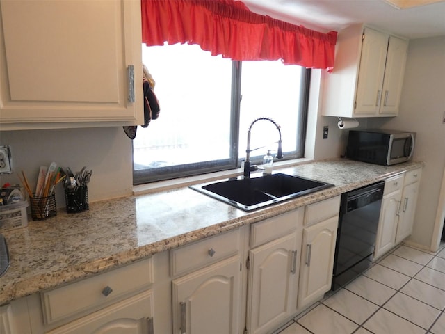 kitchen with light countertops, stainless steel microwave, dishwasher, and a sink