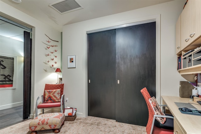 carpeted office space with visible vents and baseboards