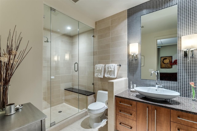 full bathroom with tile walls, tasteful backsplash, toilet, a shower stall, and vanity