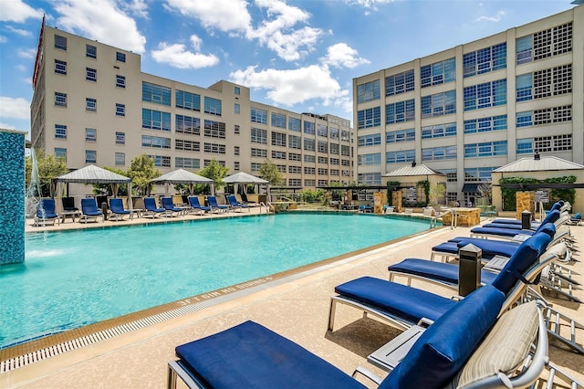 pool with a patio and a gazebo