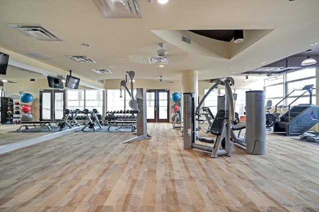 workout area featuring french doors, visible vents, and light carpet