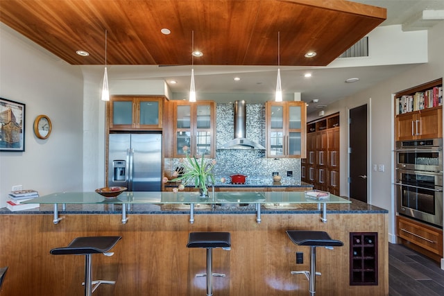 kitchen featuring wine cooler, wooden ceiling, stainless steel appliances, wall chimney range hood, and tasteful backsplash