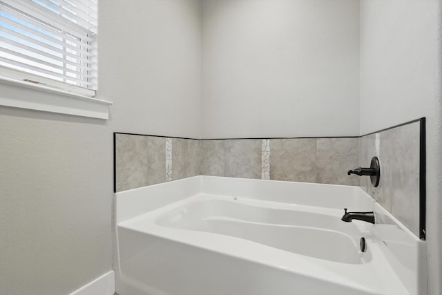 bathroom with a garden tub