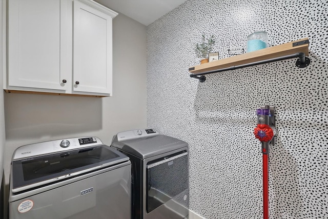 laundry room featuring cabinet space and separate washer and dryer