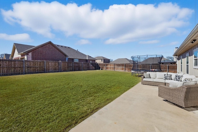 view of yard featuring a trampoline, a patio area, outdoor lounge area, and a fenced backyard