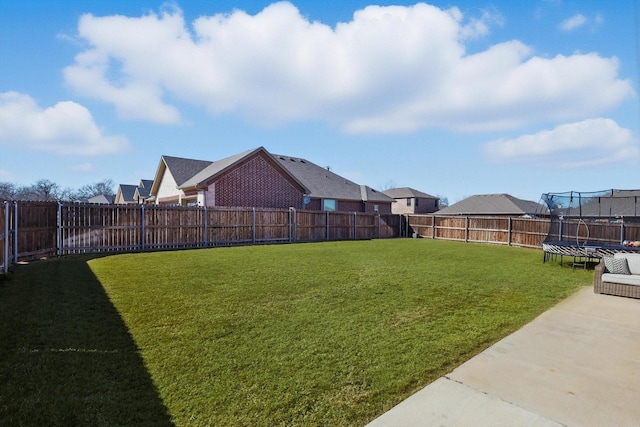 view of yard featuring a fenced backyard and a trampoline