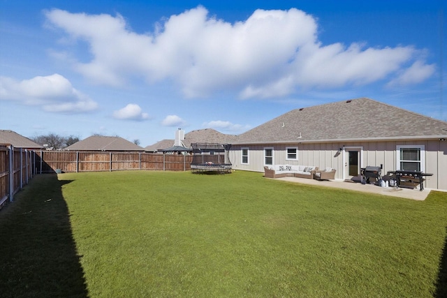 view of yard featuring a fenced backyard, a trampoline, an outdoor living space, and a patio