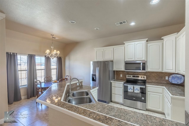 kitchen with tasteful backsplash, visible vents, tile countertops, appliances with stainless steel finishes, and a sink