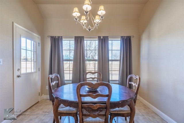 dining area featuring light tile patterned flooring, plenty of natural light, baseboards, and an inviting chandelier