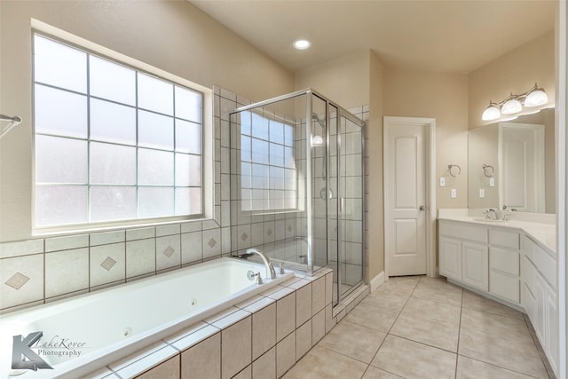 full bathroom featuring a stall shower, tile patterned flooring, a jetted tub, and vanity