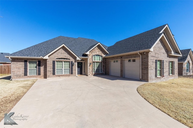 view of front of house with brick siding and a shingled roof