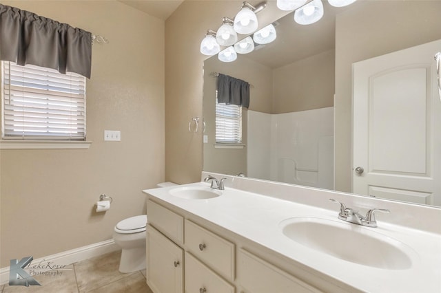 full bath featuring tile patterned flooring, a sink, toilet, and baseboards