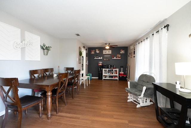 dining area with wood finished floors, visible vents, and a ceiling fan