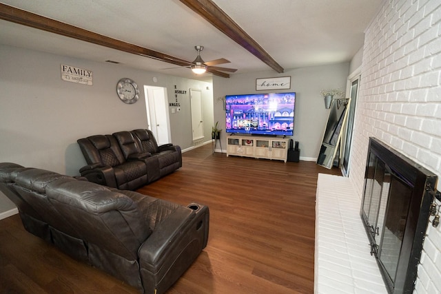 living room featuring a fireplace, wood finished floors, a ceiling fan, baseboards, and beam ceiling