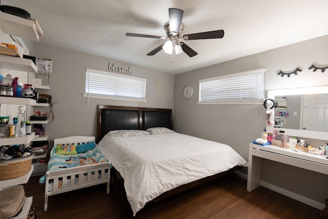 bedroom featuring multiple windows, wood finished floors, and a ceiling fan