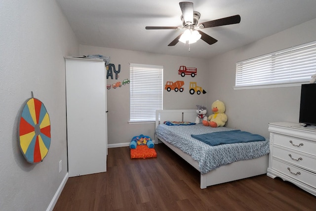 bedroom with a ceiling fan, baseboards, and wood finished floors