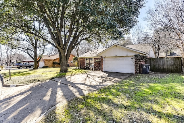 ranch-style home with an attached garage, brick siding, fence, concrete driveway, and a front lawn