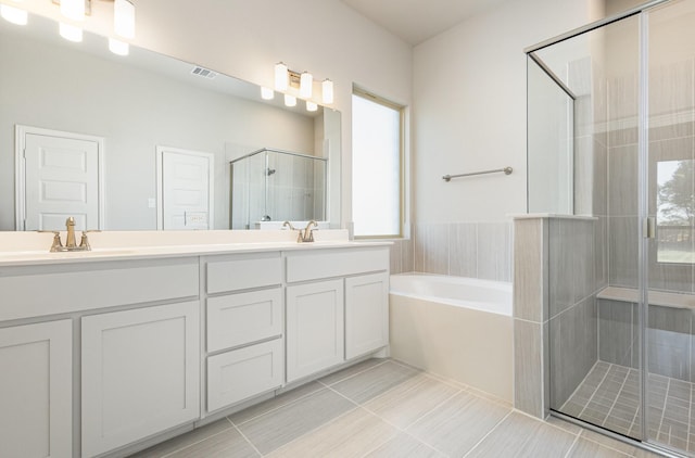 full bathroom with a garden tub, a sink, visible vents, double vanity, and a stall shower