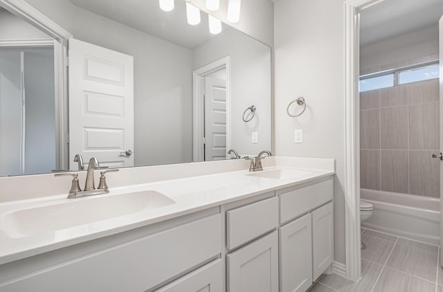 bathroom featuring a sink, toilet, and double vanity