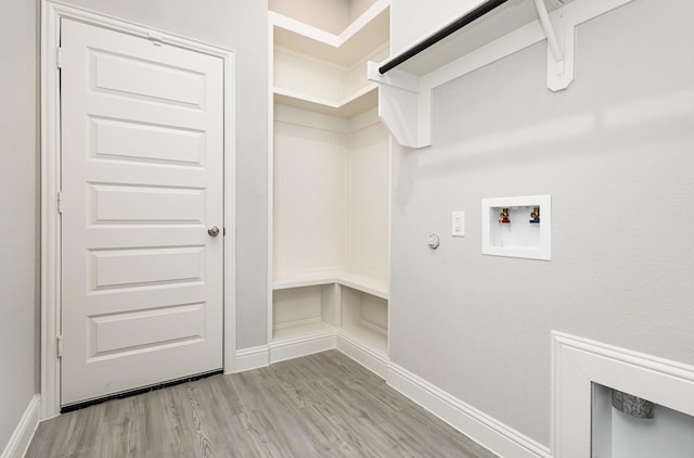 laundry area with washer hookup, hookup for a gas dryer, wood finished floors, laundry area, and baseboards