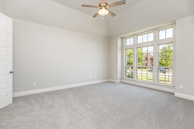 unfurnished room with carpet floors, vaulted ceiling, ceiling fan, and baseboards